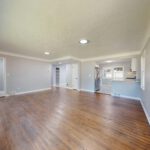 Open and bright living room with hardwood floors and natural light.